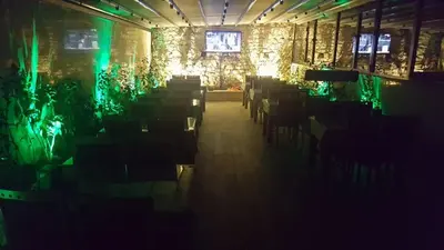 a dark room with tables and chairs and green lights at Sun Comfort Hotel in Istanbul