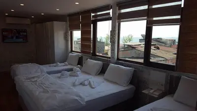 a room with two beds and two windows at Sun Comfort Hotel in Istanbul