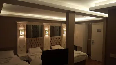 a bedroom with two beds and a tv in it at Sun Comfort Hotel in Istanbul