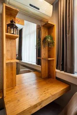 a room with wooden floors and windows with plants at Sayeban Gold Hotel in Istanbul