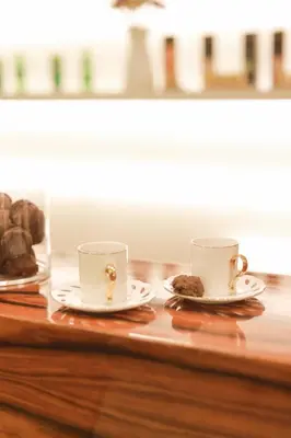 two cups and saucers on a table with cookies at Wame Suite Hotel Nisantasi in Istanbul