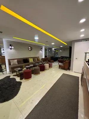 a large living room with couches and tables and yellow lighting at Wame Suite Hotel Nisantasi in Istanbul