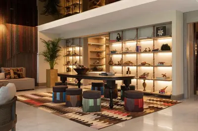 a room with a table and a display of shoes at Burdock Hotel Istanbul, Autograph Collection in Istanbul