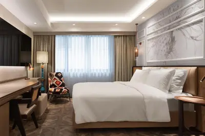 a hotel room with a bed and a desk at Burdock Hotel Istanbul, Autograph Collection in Istanbul