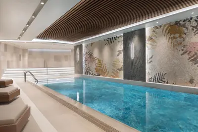 a large swimming pool in a building at Burdock Hotel Istanbul, Autograph Collection in Istanbul