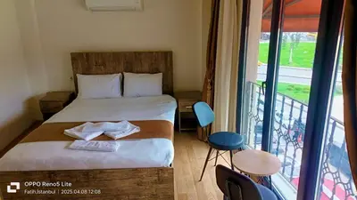 a small bedroom with a bed and a balcony at Vento in Istanbul