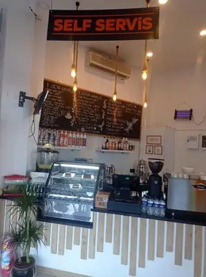 a restaurant counter with a sign on the wall at Vento in Istanbul