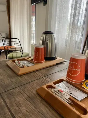 two wooden cutting boards with cups and a tea kettle at Vento in Istanbul