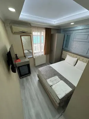 a bedroom with a large bed and a television at Grand Kybele Hotel in Istanbul