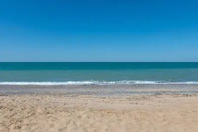 a sandy beach with the ocean in the background at Airport Black Sea Hotel & Restaurant in Arnavutköy