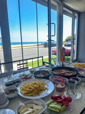 a buffet of food on a table with a view of the ocean at Airport Black Sea Hotel & Restaurant in Arnavutköy