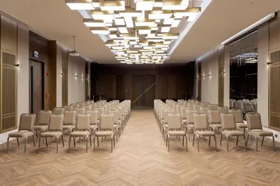 a conference room with rows of chairs and a chandelier at Wish More Hotel Şişli in Istanbul