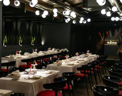 a room filled with tables and chairs with white tablecloths at Wish More Hotel Şişli in Istanbul