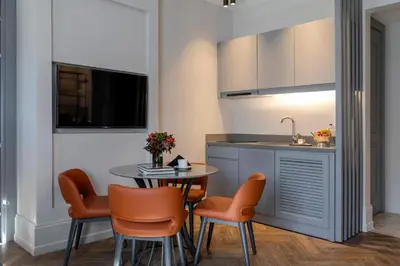a kitchen with a table and chairs and a sink at Wish More Hotel Şişli in Istanbul