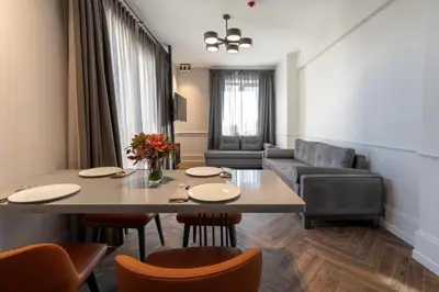 a living room with a table and a couch at Wish More Hotel Şişli in Istanbul