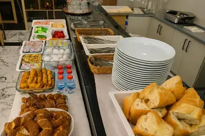 a buffet with bread and plates of food on a counter at CALENBERG HOTEL in Istanbul