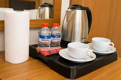 a tray with cups and bottles of water and a coffee maker at CALENBERG HOTEL in Istanbul