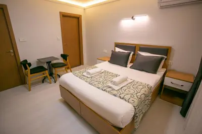 a bedroom with a large bed with two towels on it at BLAU GRÜN İSTANBUL OTEL in Istanbul