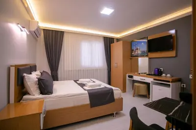a hotel room with a bed and a desk at BLAU GRÜN İSTANBUL OTEL in Istanbul