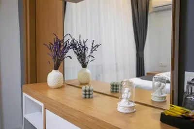 two vases with flowers on a table in a bedroom at BLAU GRÜN İSTANBUL OTEL in Istanbul