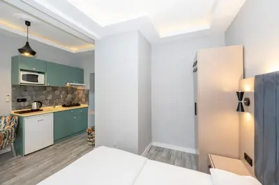 a kitchen with green cabinets and a white refrigerator at Cirrus Suites in Istanbul