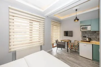 a kitchen with wooden blinds in a room with a table at Cirrus Suites in Istanbul