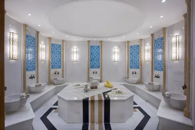 a bathroom with three sinks and three toilets in it at The Parma Hotel & Spa Taksim in Istanbul