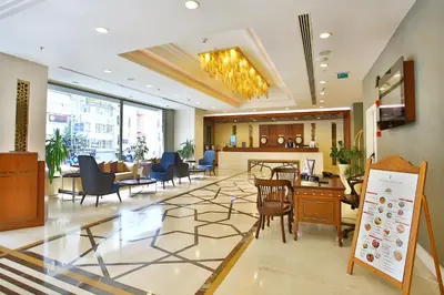 a lobby with chairs and tables in a building at The Parma Hotel & Spa Taksim in Istanbul