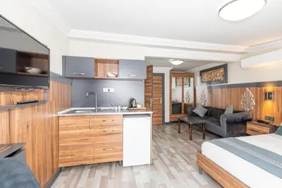 a kitchen and living room with a bed and a sink at La Serena Taxim Hotel in Istanbul