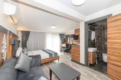 a hotel room with a couch and a bedroom at La Serena Taxim Hotel in Istanbul