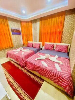two beds sitting next to each other in a bedroom at White Suites Hotel İstanbul in Istanbul