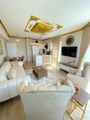 a living room with white couches and a tv at King Panorama Suite HI9 in Esenyurt
