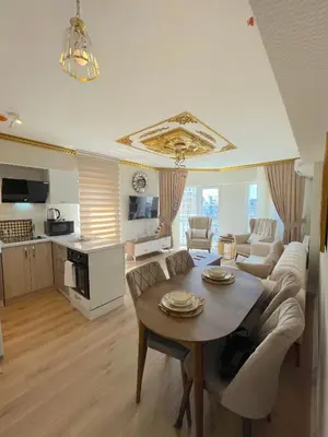 a living room with a couch and a table at King Panorama Suite HI9 in Esenyurt