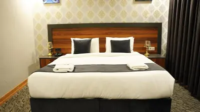 a bedroom with a large bed with two towels on it at El Emin İstanbul Hotel in Istanbul