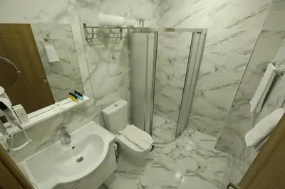 a bathroom with a toilet and a shower and a sink at El Emin İstanbul Hotel in Istanbul