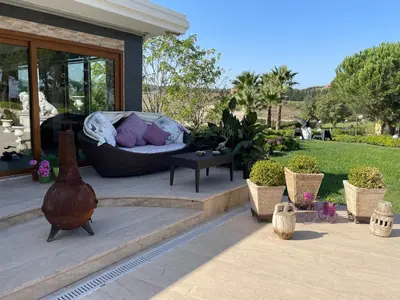 a patio with a couch and a table with plants at Büyükbalkan Mansion, Charming Farmhouse, Altınova Yalova in Altınova