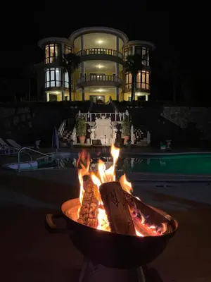 a fire pit in front of a building at night at Büyükbalkan Mansion, Charming Farmhouse, Altınova Yalova in Altınova