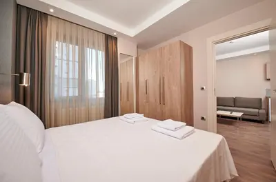 a bedroom with a large white bed and a couch at Livinton İstanbul Ataşehir in Istanbul
