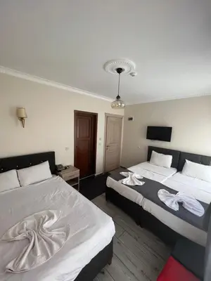 a hotel room with two beds with towels on them at Oren Hotel in Istanbul