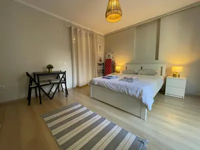 a bedroom with a bed and a table and a desk at Apt w/ Balcony in center,5 mn walk to Istiklal in Istanbul