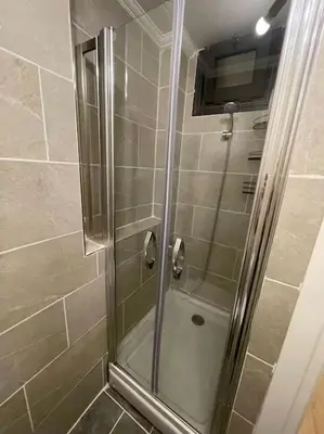 a shower with a glass door in a bathroom at Apt w/ Balcony in center,5 mn walk to Istiklal in Istanbul