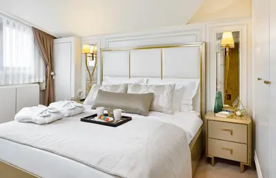 a large white bed with a tray of food on it at Ulus G Residences in Istanbul