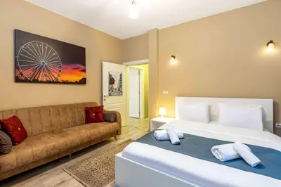 a bedroom with a large bed and a couch at Cihangir rooms in Istanbul