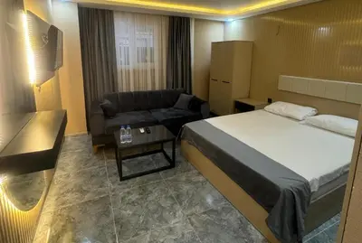 a hotel room with a bed and a couch at Asem Palace in Istanbul