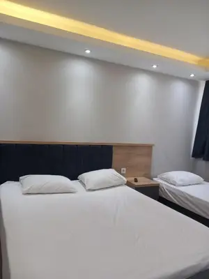 a bedroom with two beds with white sheets at Asem Palace in Istanbul