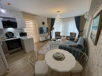 a living room with a couch and a table at King Suite OK0 in Esenyurt