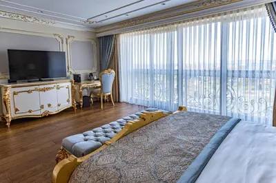 a bedroom with a large bed and a large window at Dekalb Hotel in Istanbul