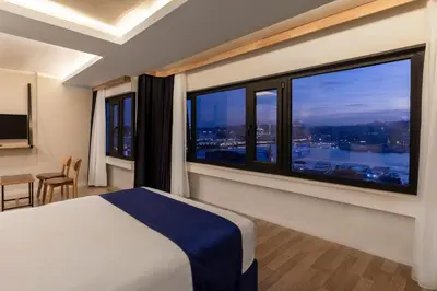 a bedroom with a bed and a large window at Union Hotel Karaköy in Istanbul