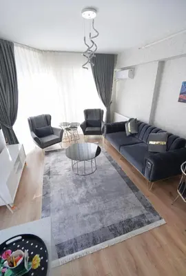 a living room with a couch and a table at King Suite TH28 in Esenyurt