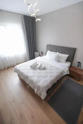 a bedroom with a bed with two slippers on it at King Suite TH28 in Esenyurt